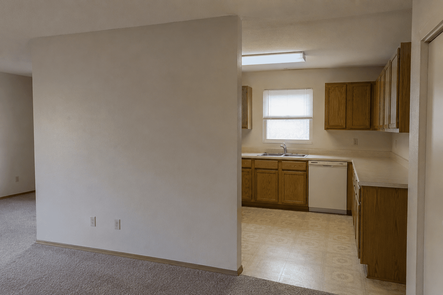 Before — closed-off kitchen and carpeted room in Silver Spring, MD